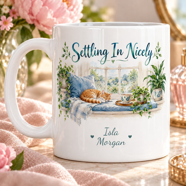 Settling In Nicely – Personalised Mug — peaceful watercolour window nook, blue cushion, steaming tea, green houseplants and small sleeping ginger cat