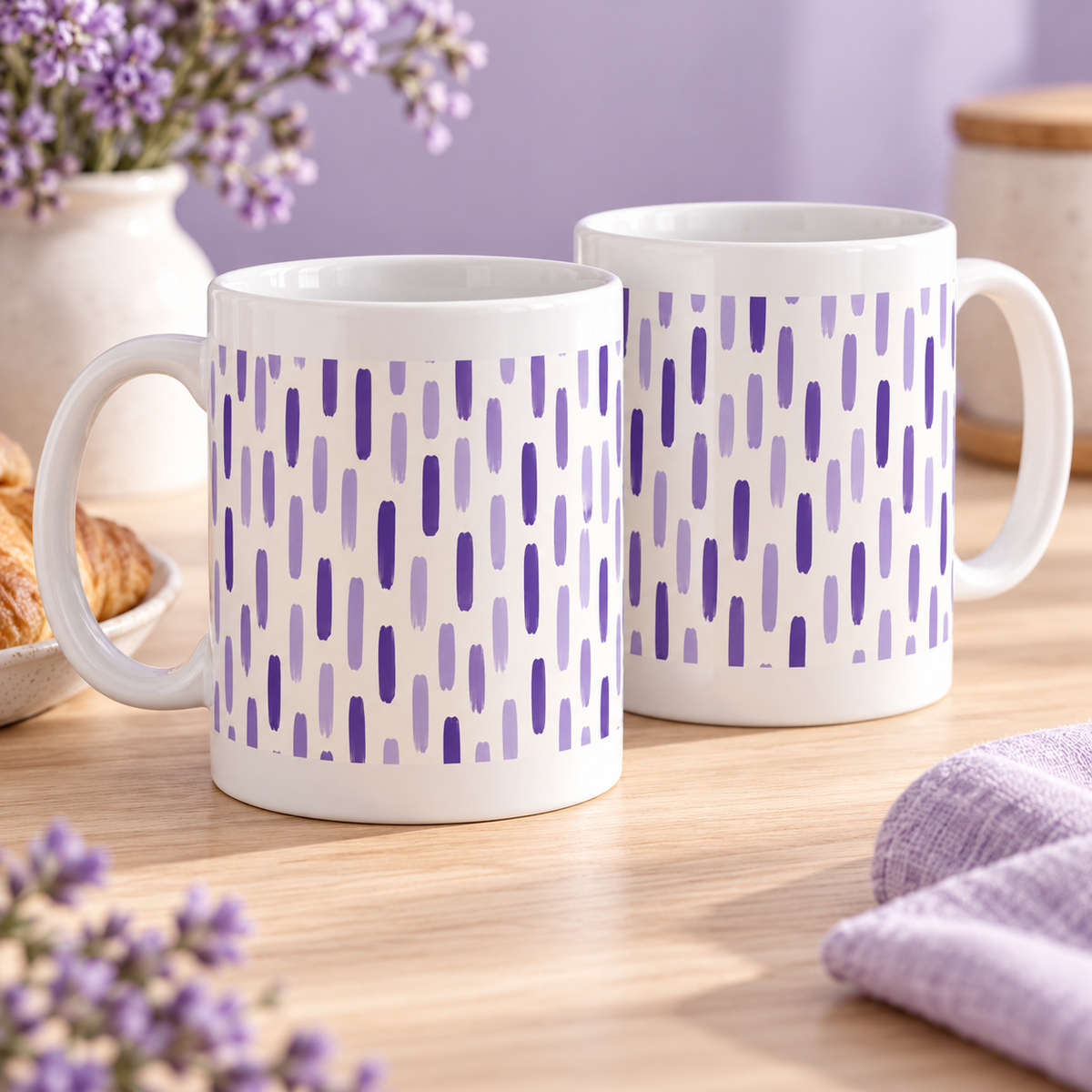 Two white ceramic mugs with lavender and violet broken stripe segments