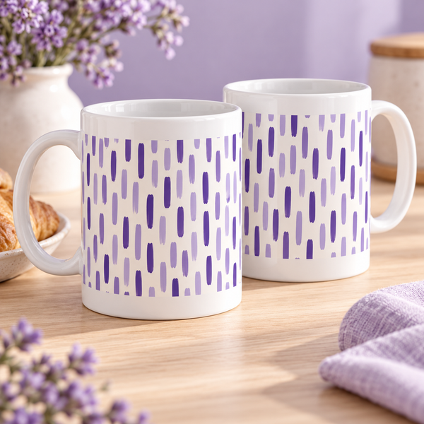 Two white ceramic mugs with lavender and violet broken stripe segments
