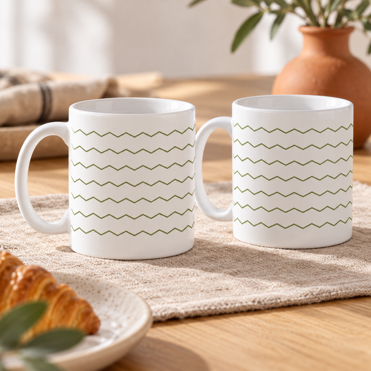 Olive Herringbone Ceramic Mugs – Set of 2 with matching printed designs, white ceramic borders and both handles on the left